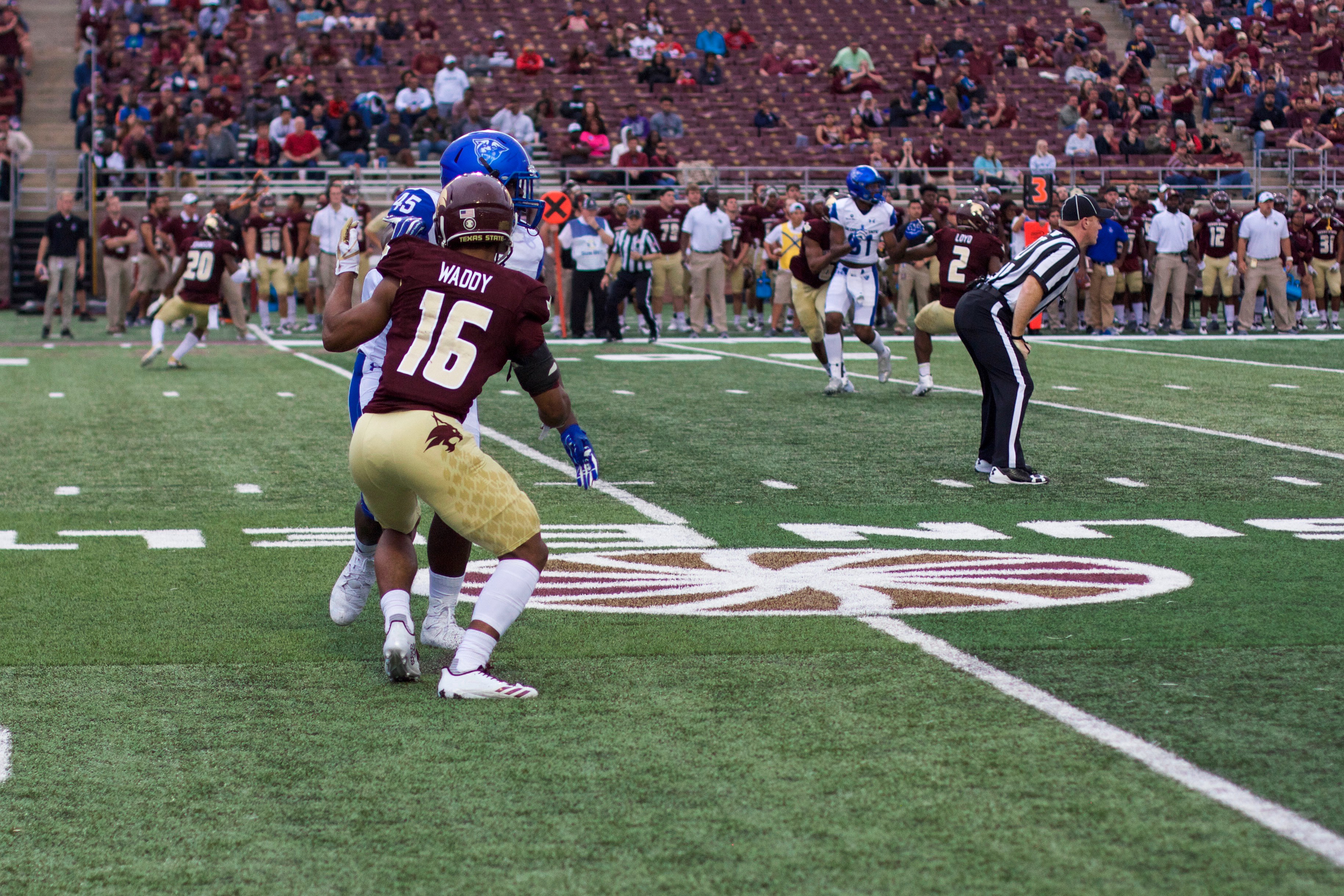 Jashon Waddy, number 16, combats a white jersey, blue-helmeted Georgia State wide receiver, number 45, on the peripheral of the field. Last season, Waddy was a cornerback who fought with an urgent physicality; him leading in that same style will be a major factor against the New Mexico State spread.