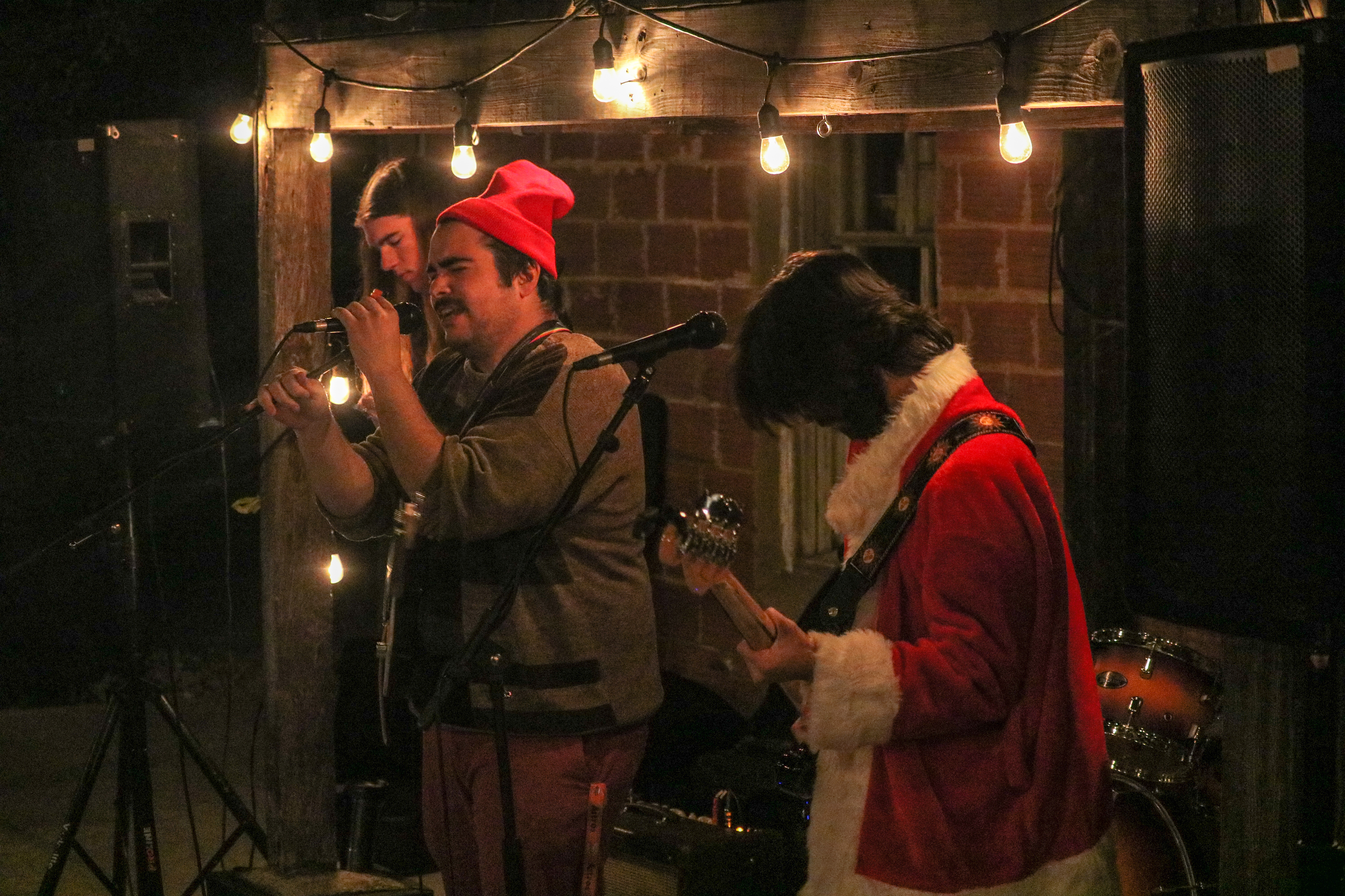 Members of the band GOOD. during playing instruments and singing.