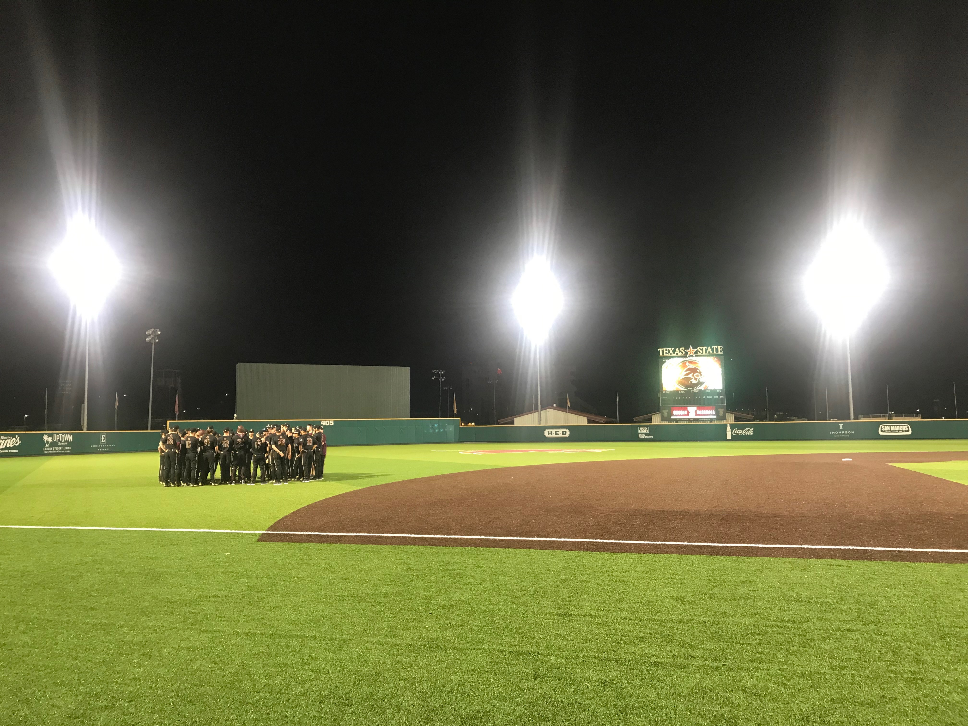 The Bobcats are gathered by the coaches after the game to discuss the takeways and to dismiss the team after a great win on opening night.