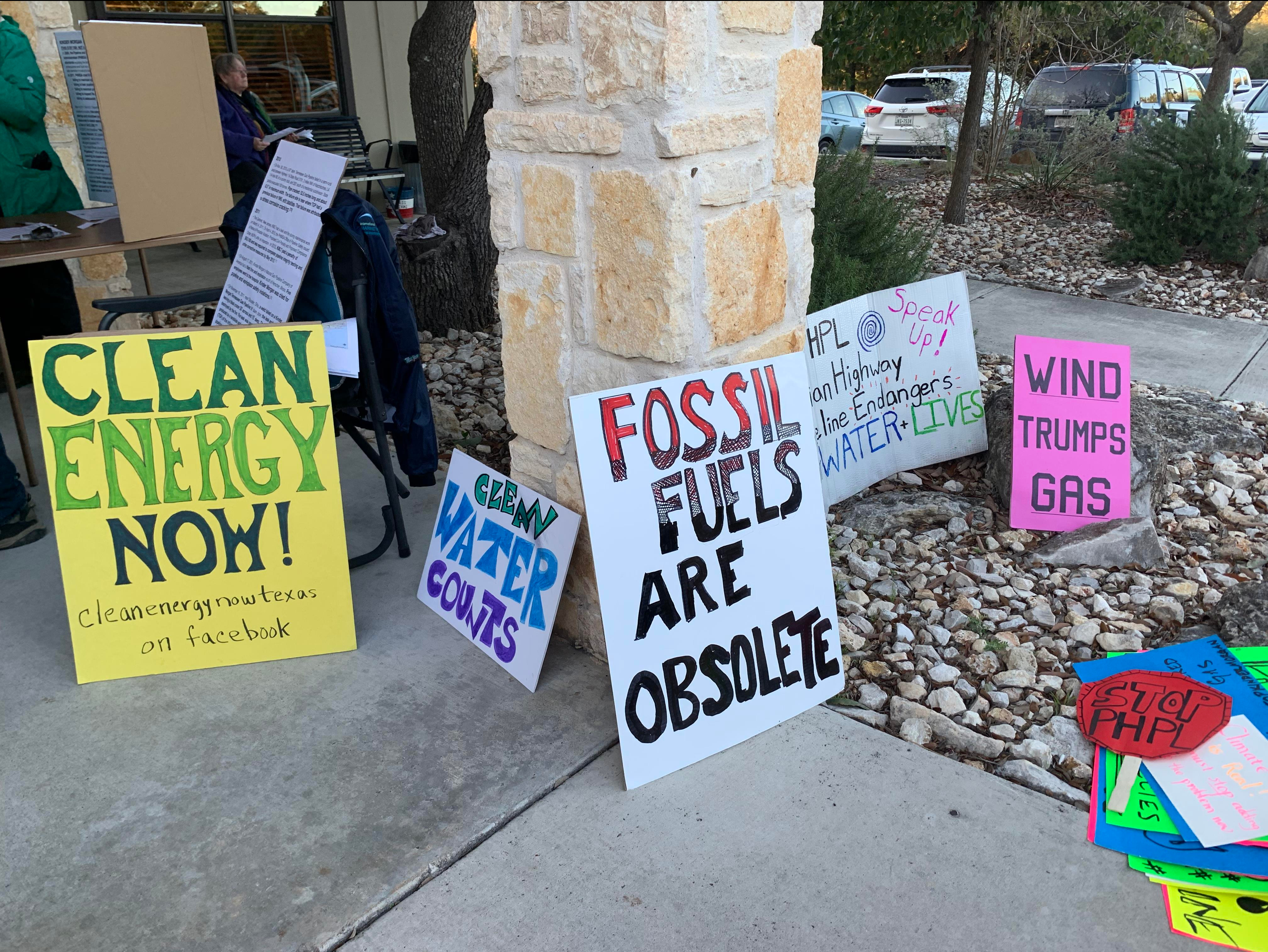 Signs that are anti-pipeline such as clean energy now are placed along the Wimberley Community Center