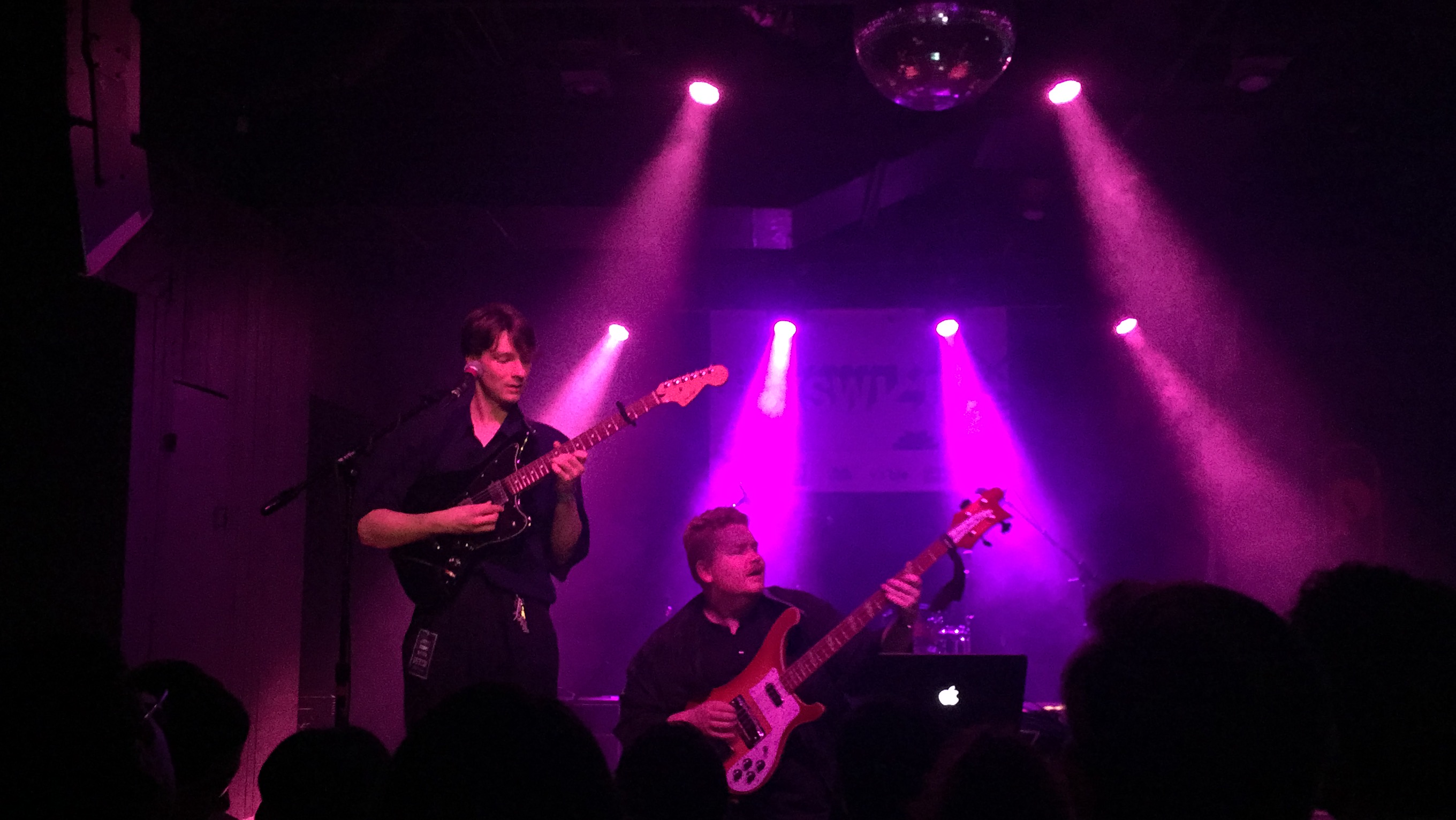 Singer Stephen Fitzpatrick and bassist Auden Laading of Her’s performing on a pink stage at The Parish on 6th Street in Austin, Texas during SXSW.