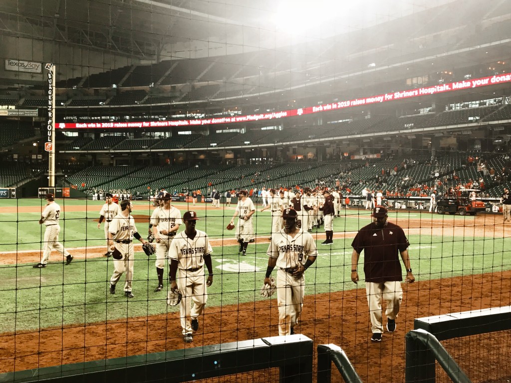 Texas State Baseball players head to the dugout.