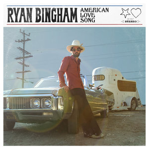 Ryan Bingham leaning on an old car in the desert for the album cover