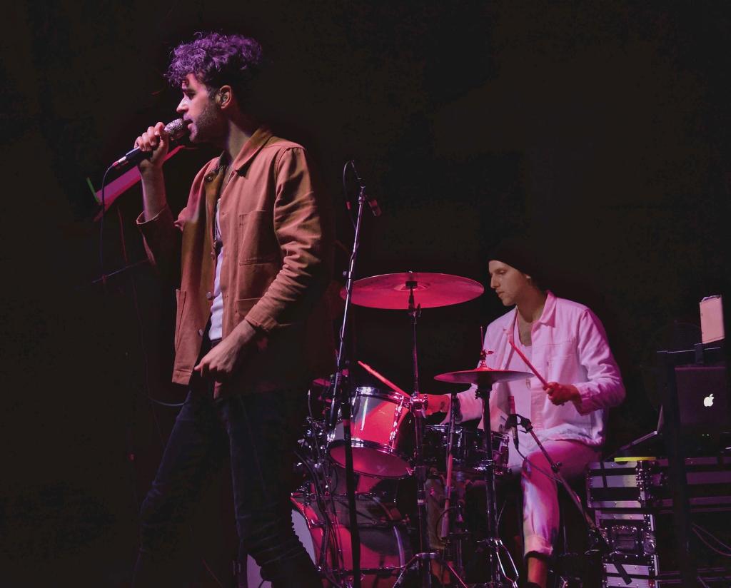 Man singing and man playing drums