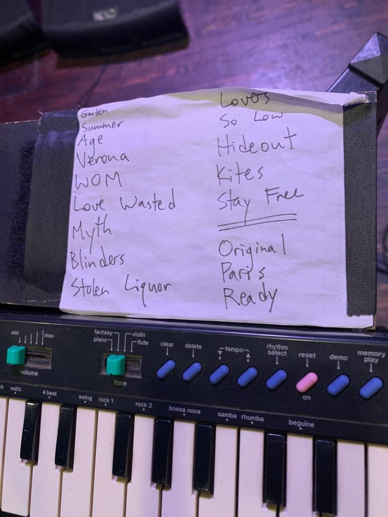 paper with set list written out on a keyboard.