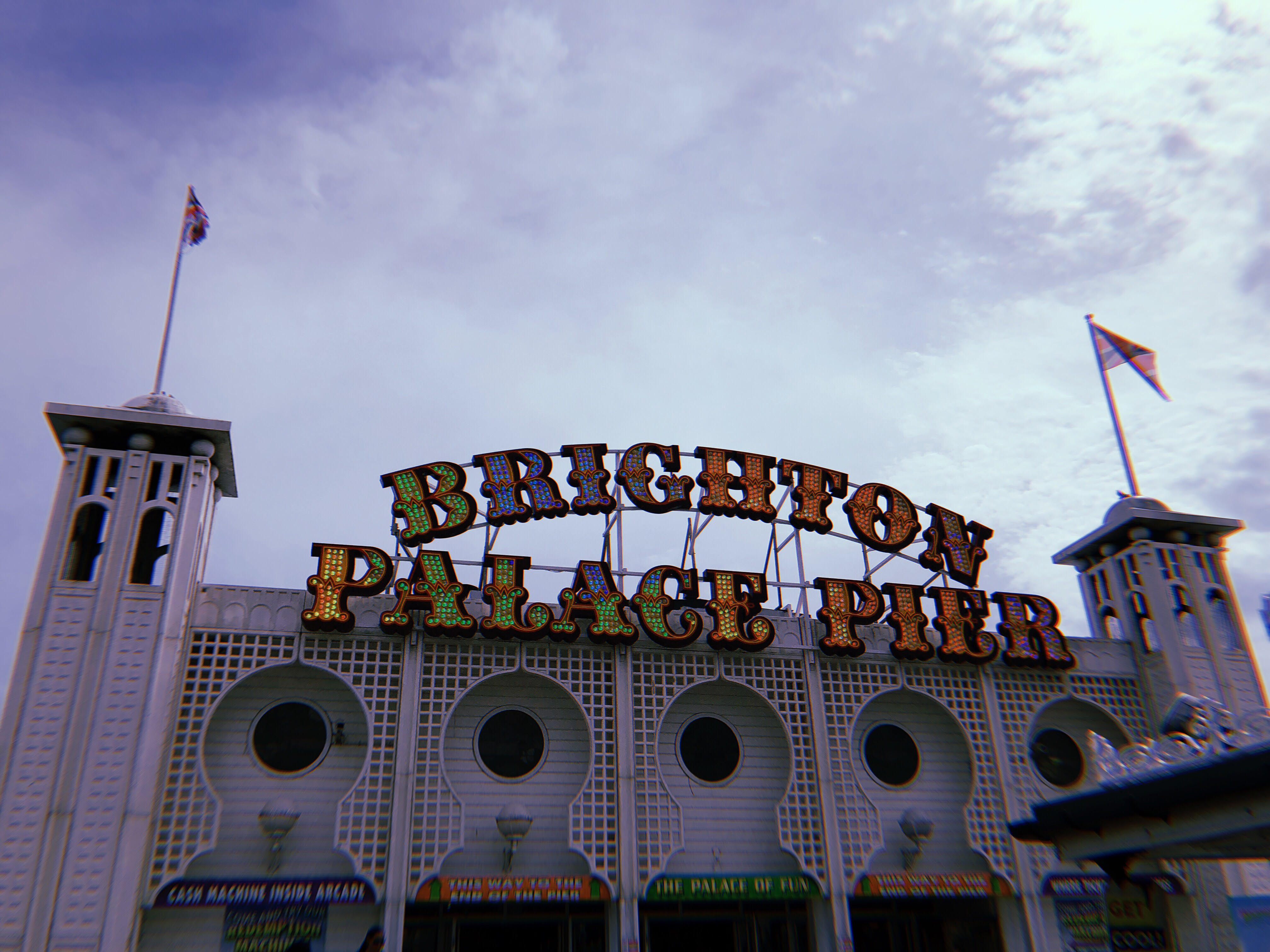 A photo of Brighton Palace Pier’s colorful light up sign.