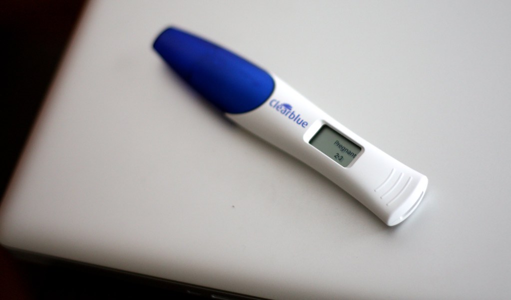 Blue and white positive pregnancy test