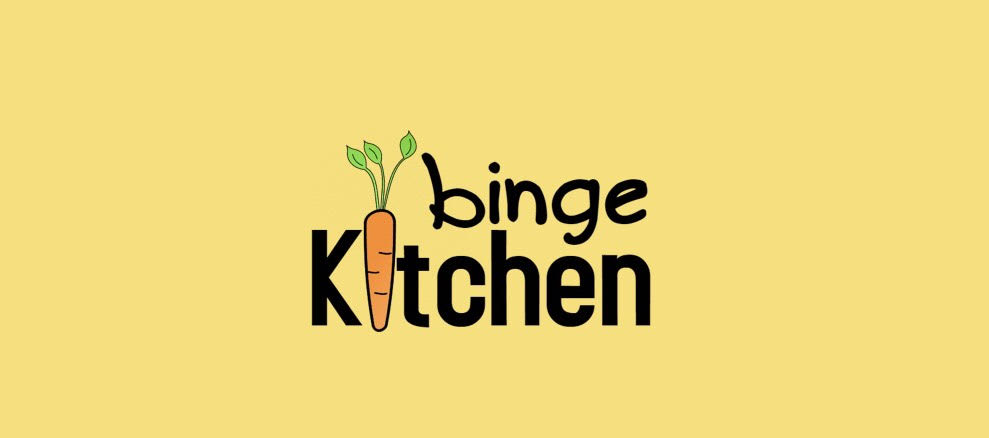 A yellow background with the words “Binge Kitchen,” the i in Kitchen being an orange carrot