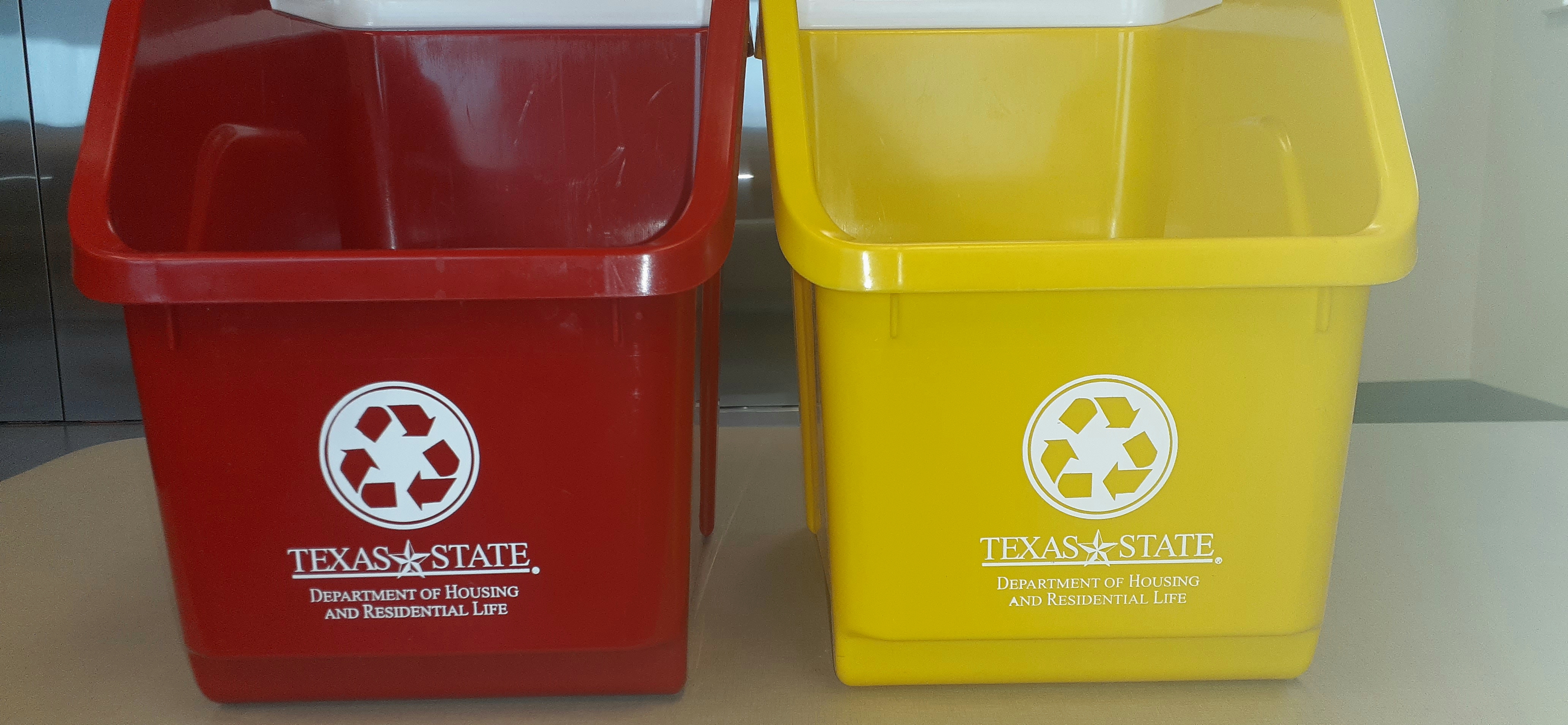 Red and yellow bins sit next to each other with the words Texas State Department of Housing and Residential Life in white letters written in the center of the bin.