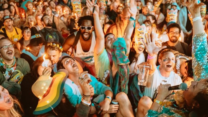 An up close shot of a crowd of people during a festival set