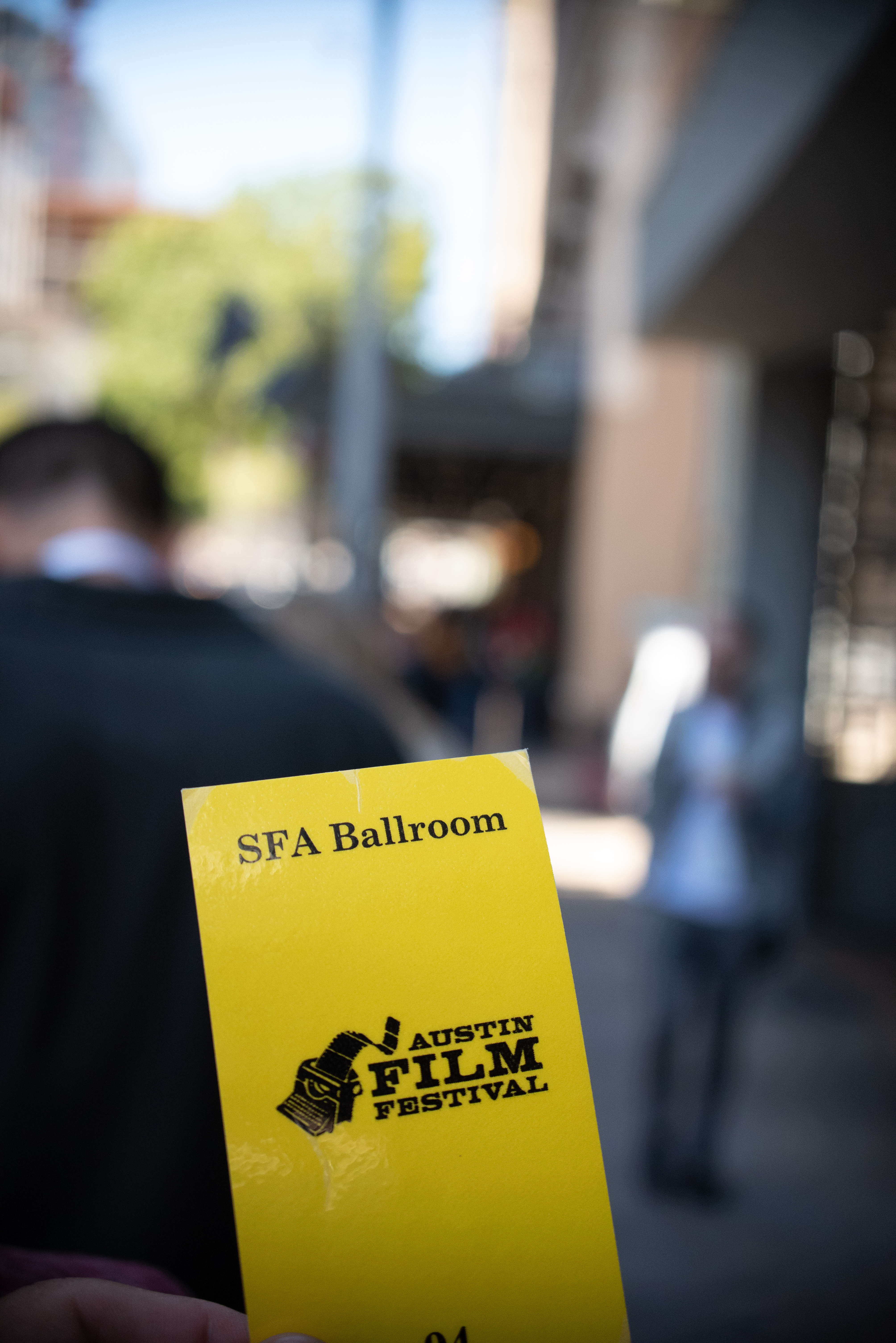 Yellow ticket with the word SFA ballroom and Austi Film Festival written on it.