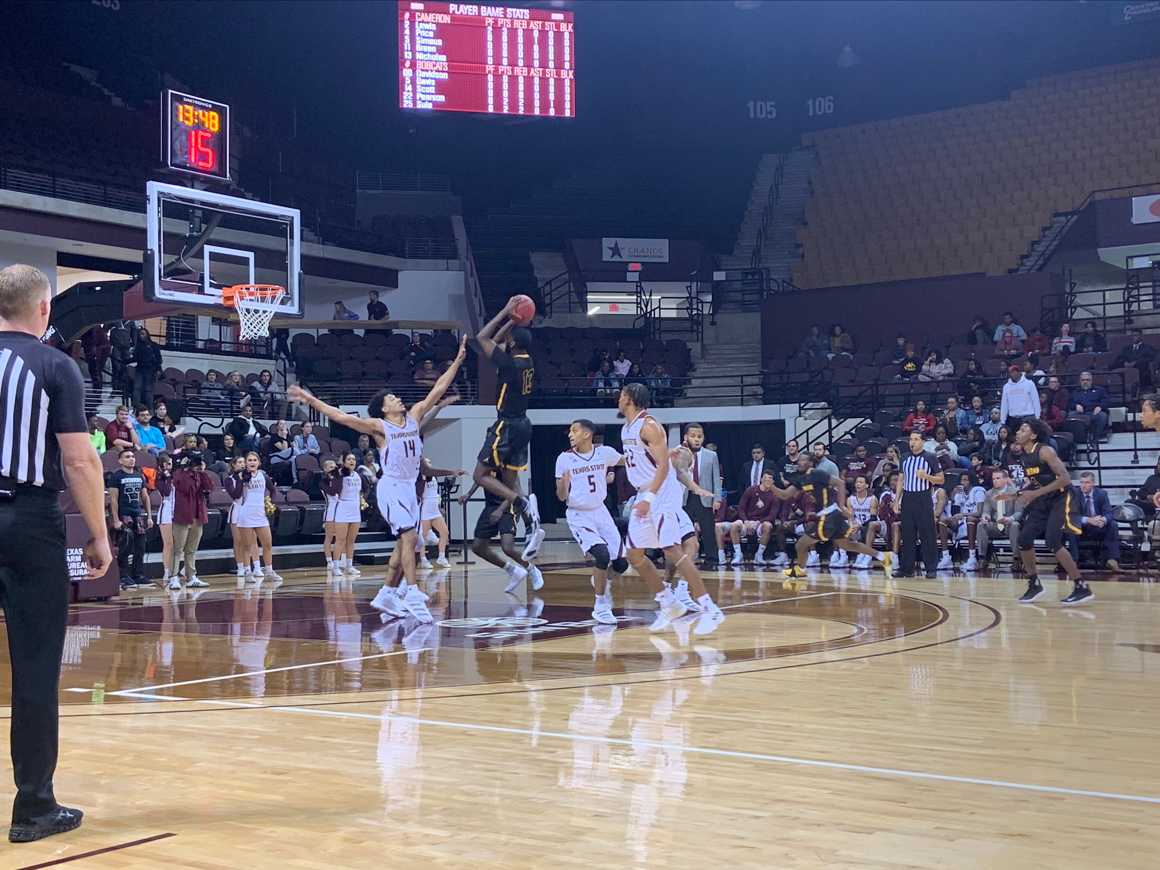 Texas State in the white uniforms defend against the shot from Cameron in the black uniforms.