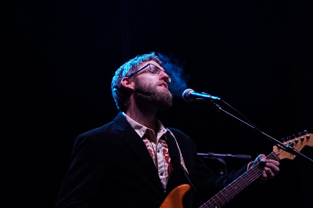 Lowell Carrico exhaling between notes on a cold night blowing hot air