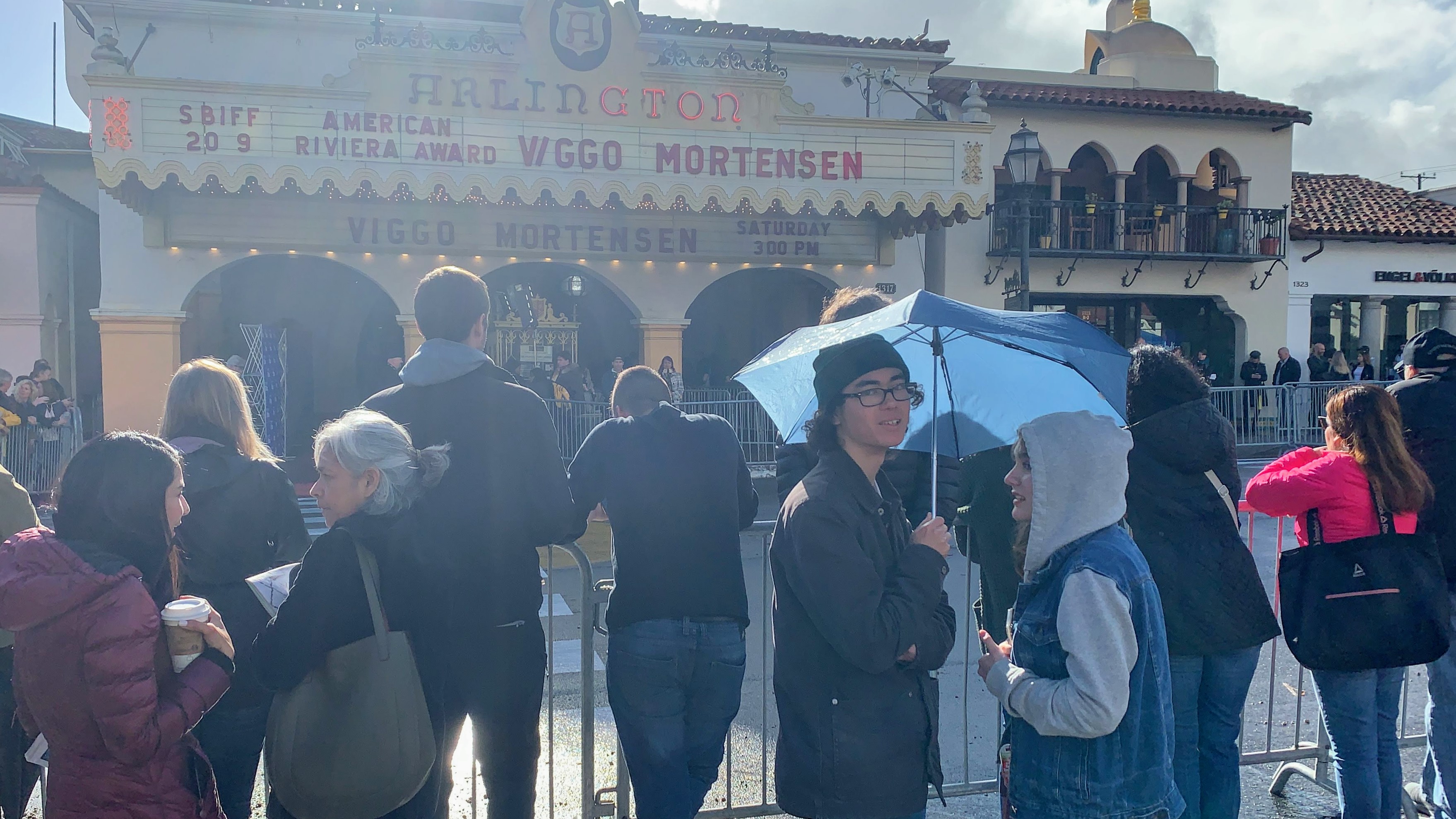 Early Moring. Crowed gathers around barricade fence outside theater