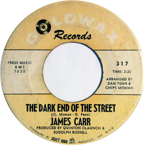 Yellow and white face with a large whole in the center. The words “Gold Wax” are written along the top of the record. The songwriters “C. Moman and D. Penn” are listed on the record as well. The image also includes the record’s title, and catalog numbers.