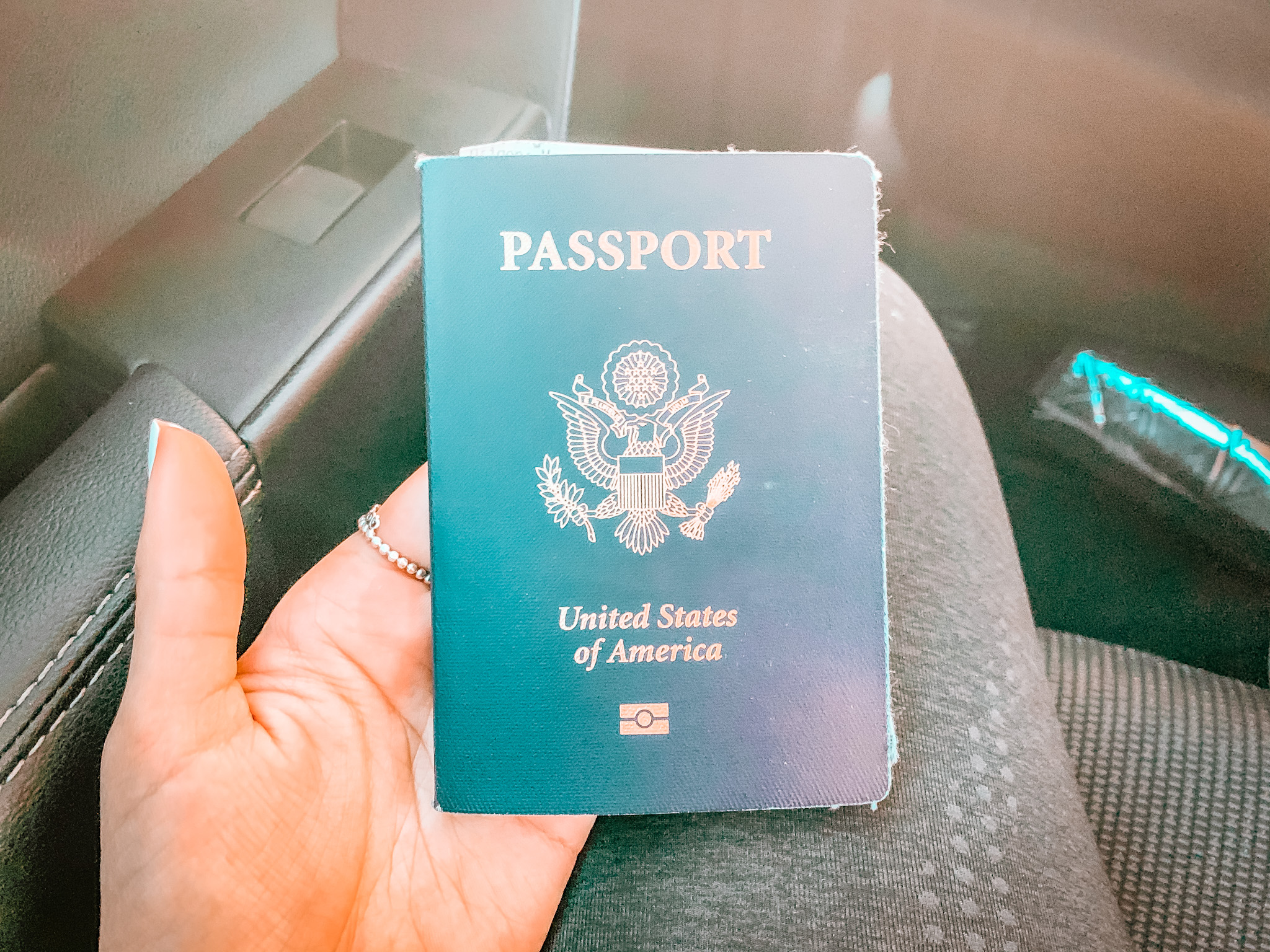 The gold United States seal with an eagle in the center is on the cover of a green American passport