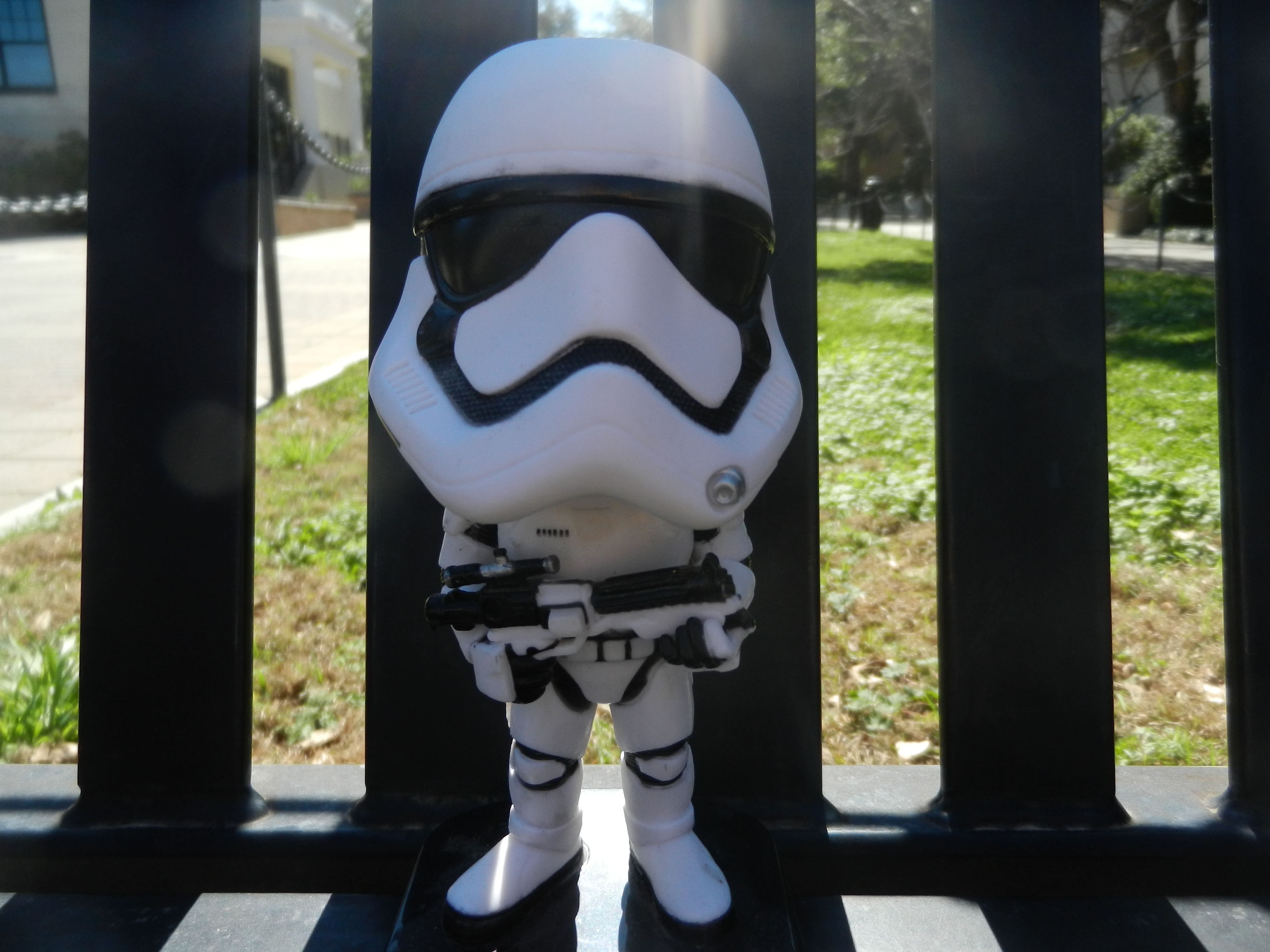A bobble head of a Stormtrooper leans against the bench.