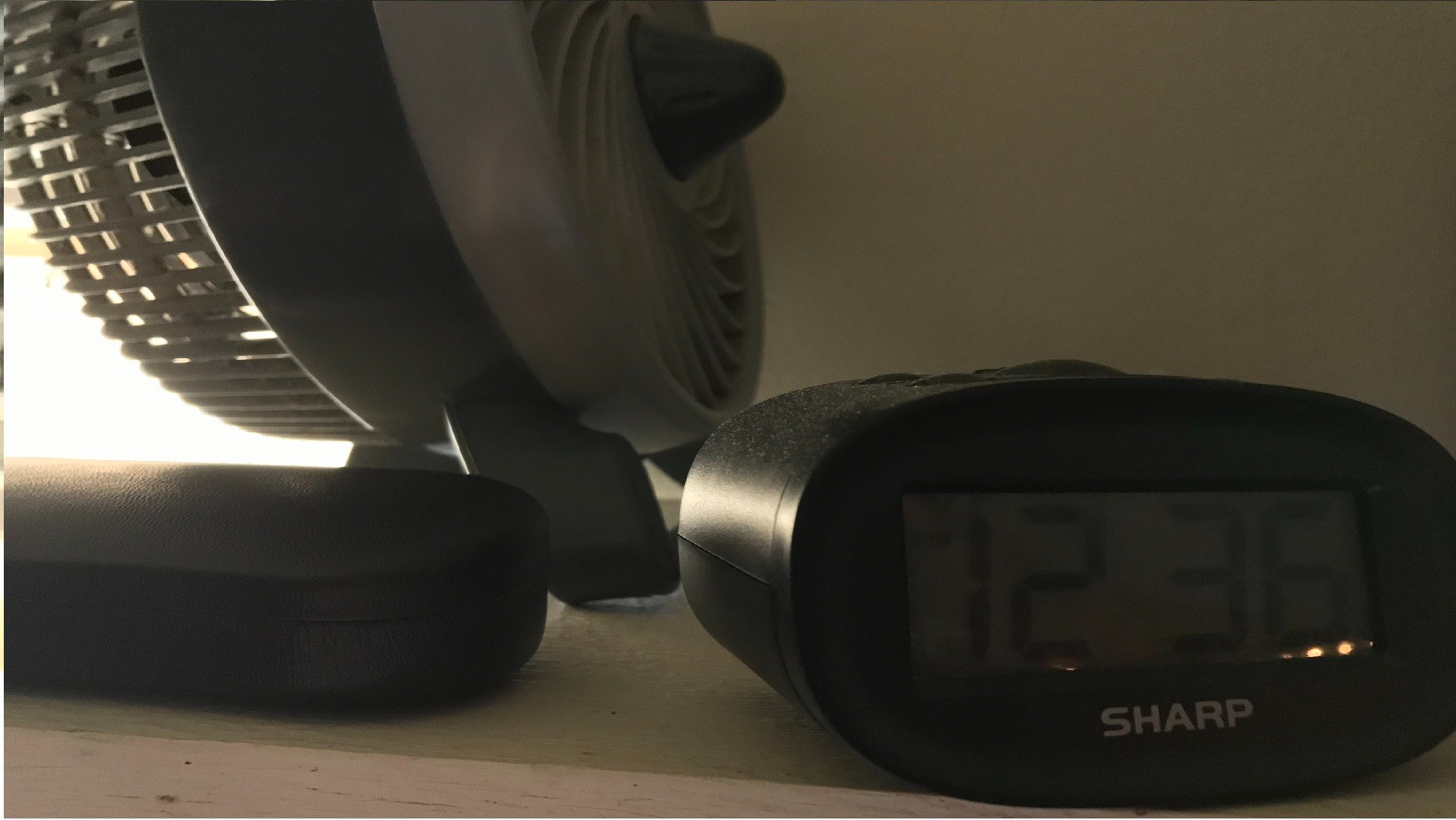 An alarm clock sits bottom right in a somewhat aesthetic manner.