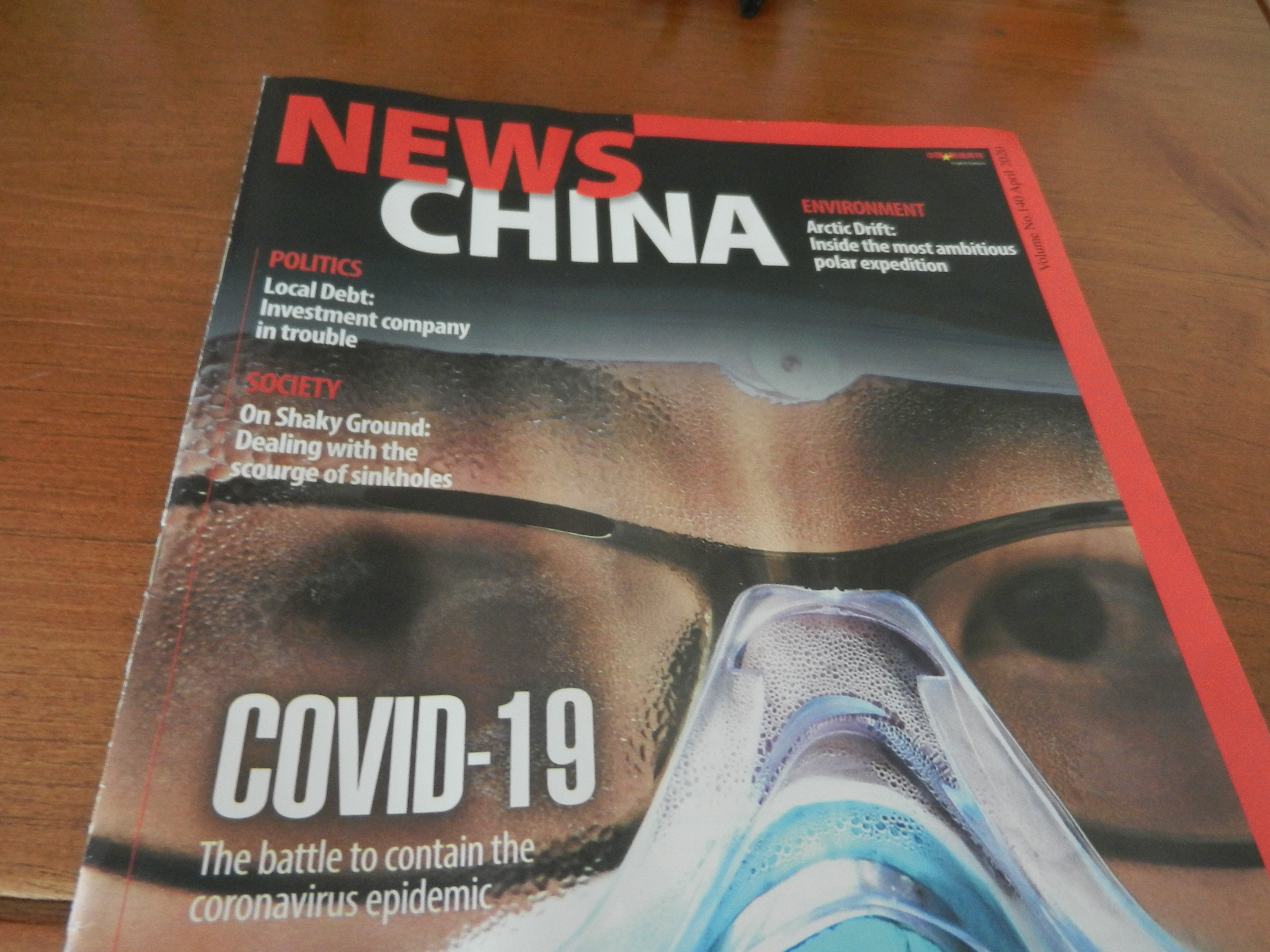 A News China magazine sits on top of a dresser.