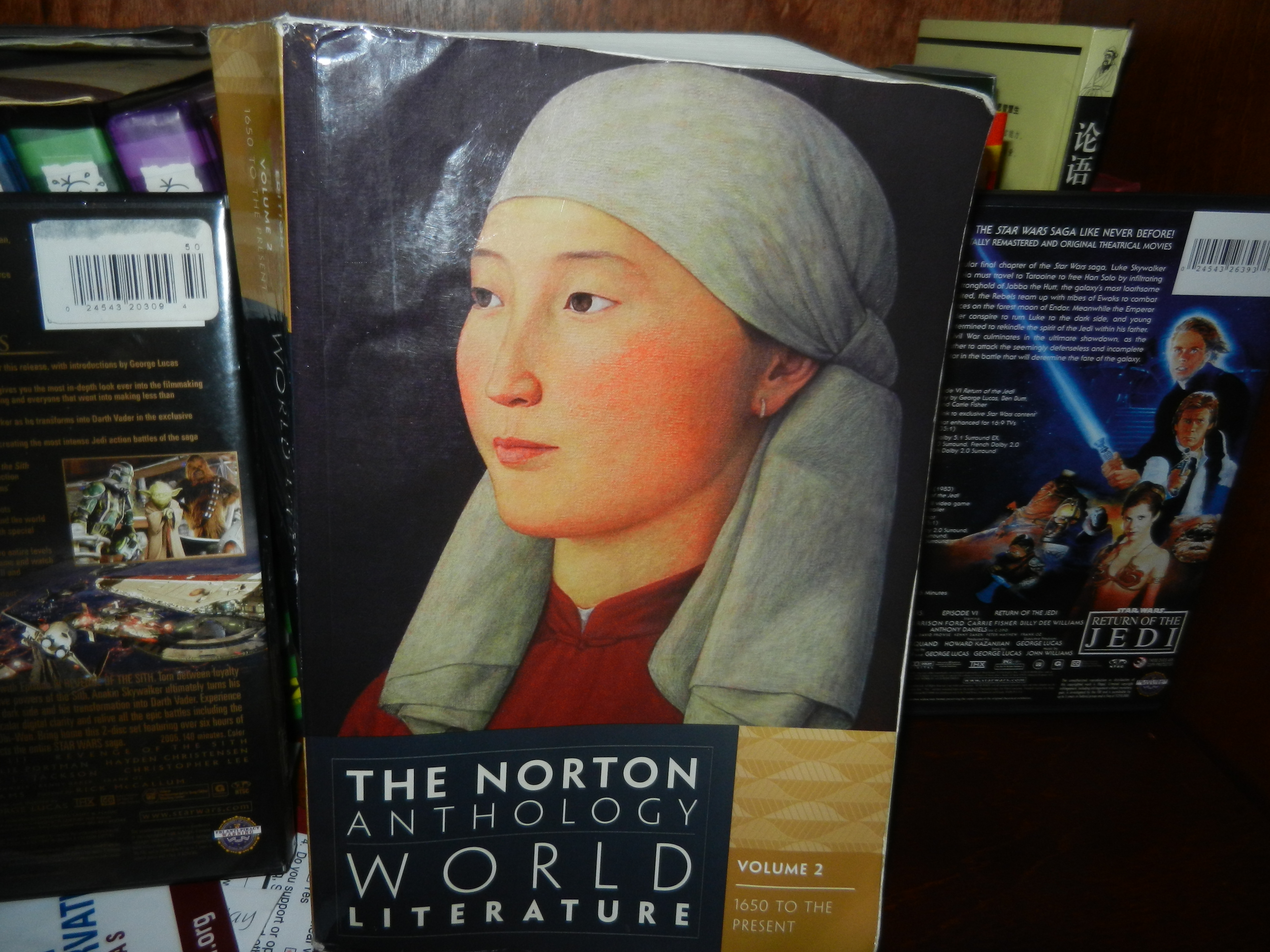 A World Literature textbook sits on a bookshelf.