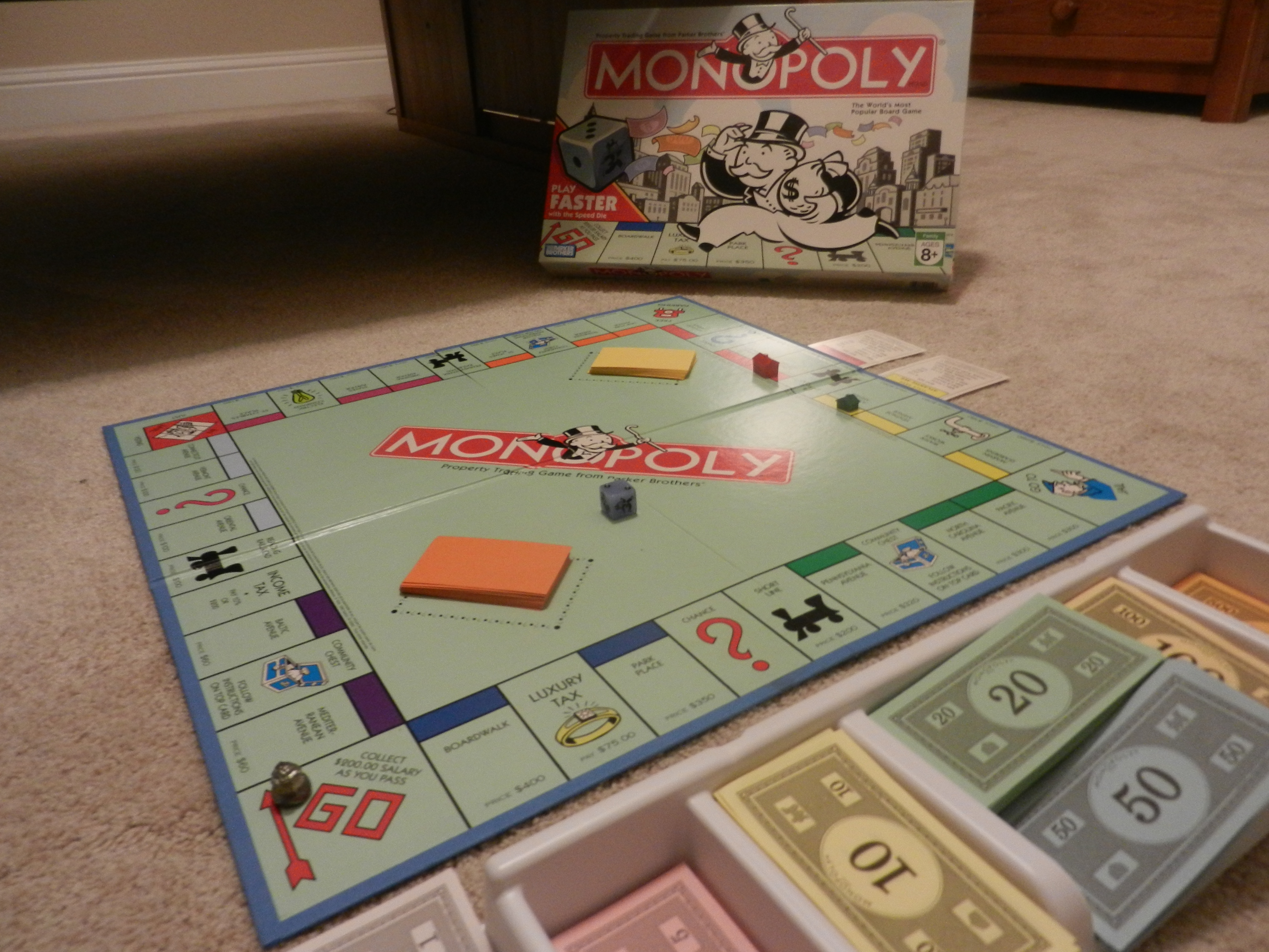 A game of Monopoly set up with a speed dice.