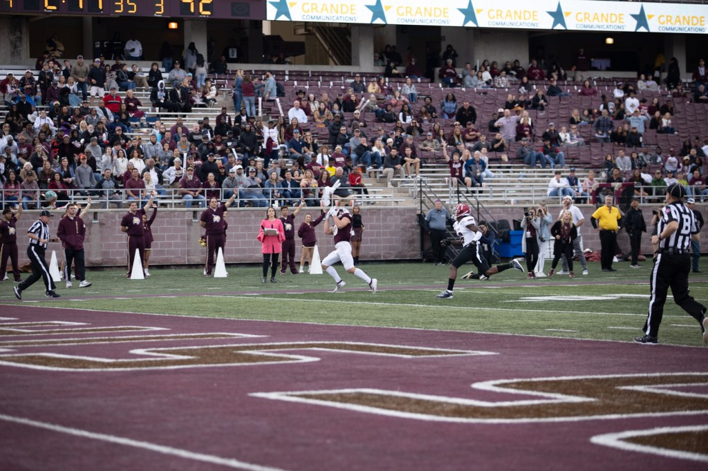 Senior Hutch White makes the catch with the football in his face around the 7-yard line. Fans are in the background amazed by the catch.