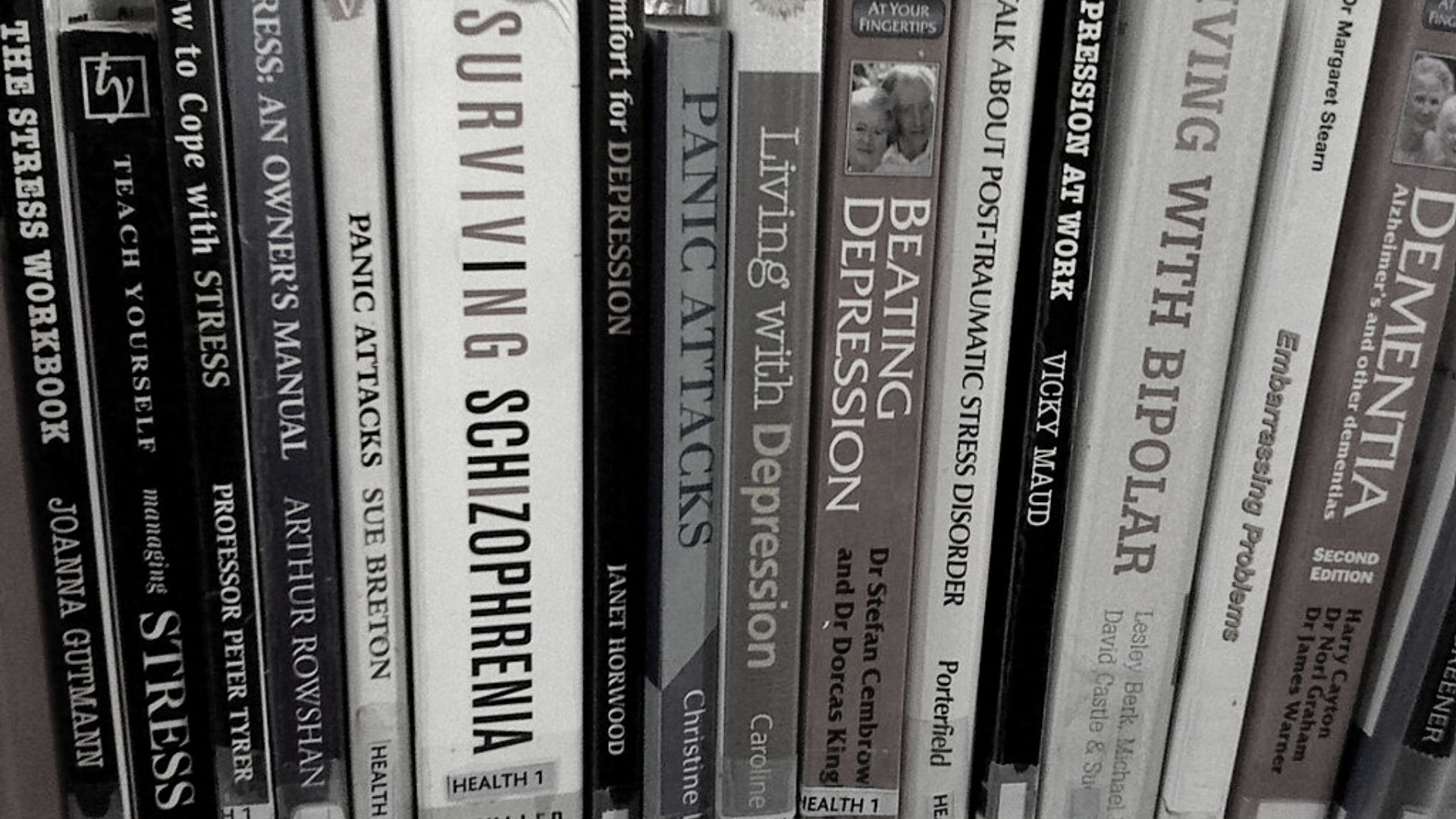 Photo showing different books about mental health topics such as schizophrenia, battling depression, dementia stress and panic attacks.