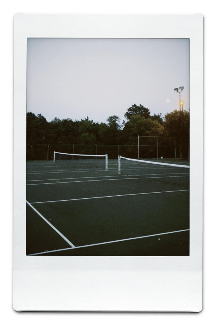 : photo of an empty tennis court at dusk