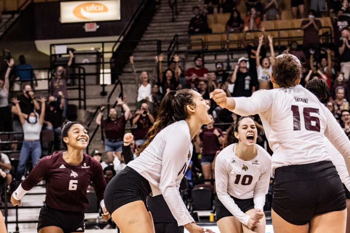 Texas State volleyball players celebrate during the game versus Texas A&M