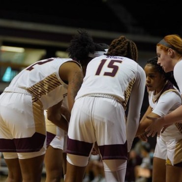 The Texas State Women's basketball team is in a huddle.