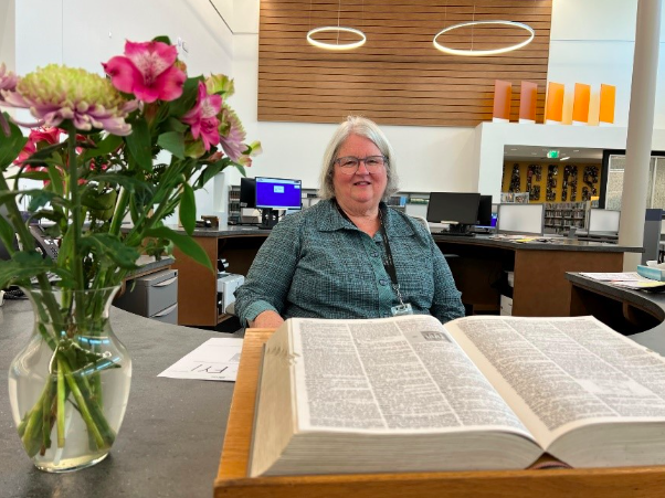 Library director Diane Insley often works directly with patrons. This day she was working the front desk. Photo Credit: Joseph Castro/KTSW News special contributor