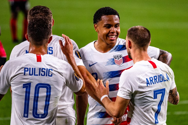 McKennie, Arriola and Pulisic are celebrating a goal