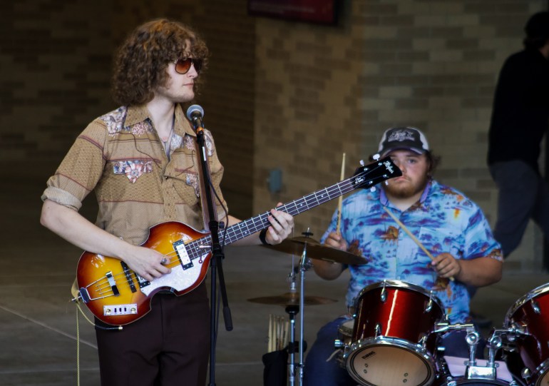 The Trips bass player and drummer performing on set.