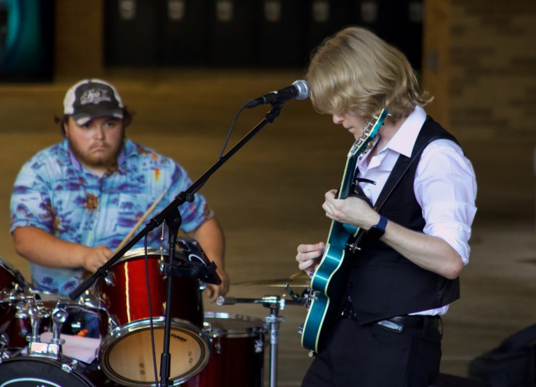 The Trips singer Sammy Wells on lead guitar and mic.