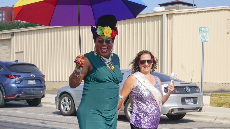 Brianna St. James and the Grand Marshal walking for SMTX Pride