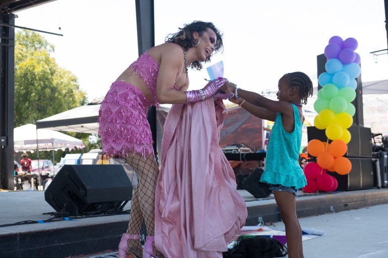 A drag queen bonding with a local girl at SMTX Pride.