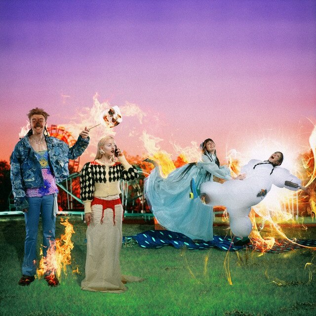 The members of FIZZ stand ablaze under a purple sky. From left to right: A man stands holding an oversized roasted marshmallow on a stick, a woman stands on the phone while her hair burns, a woman in a blue dress pushes a woman in a white, puffy inflated suit. 
