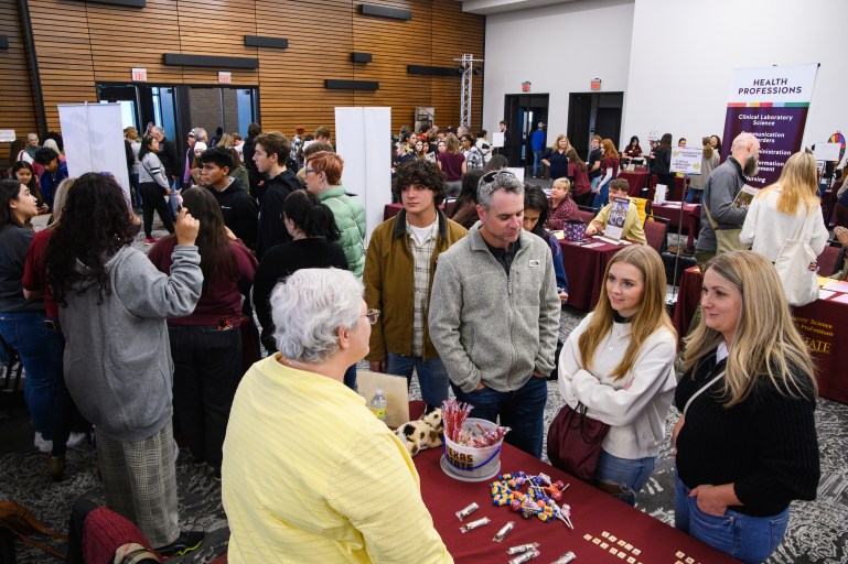 Bobcat day attendees being helped by TXST staff on what the university has to offer