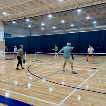 a group of people playing pickleball at San Marcos Activity center.