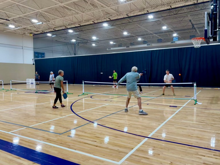 a group of people playing pickleball at San Marcos Activity center.