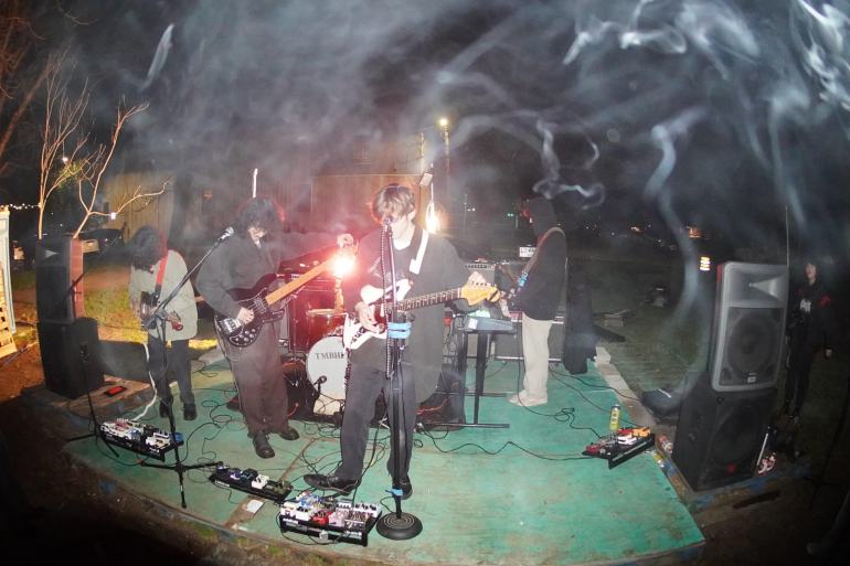 : Local Texas band “Witches Exist” playing at private park as incense burns on the microphone.