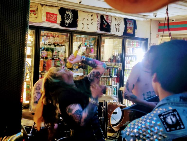 Swamp Wench takes the stage with her band, Throat Piss, at convenient store show at Rio Mart