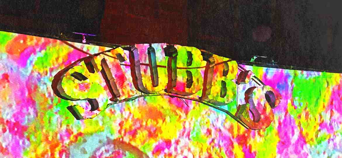 Psychedelic rainbow tie dye projection on the Stubb’s logo