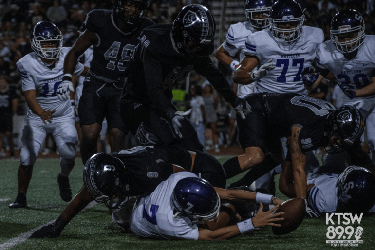 Sophomore quarterback Kane Hernandez is trying to recover the ball as he’s being tackled. | Kate Maddison  