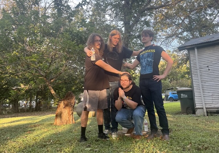 Four Piece Band “Humble House” posing alongside each other in an outside area