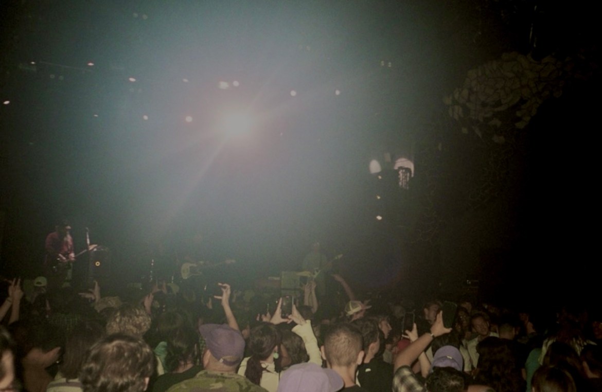 Crowd shot of Duster playing at Emo's Austin. Taken on film. A light glare cascades over the crowd.