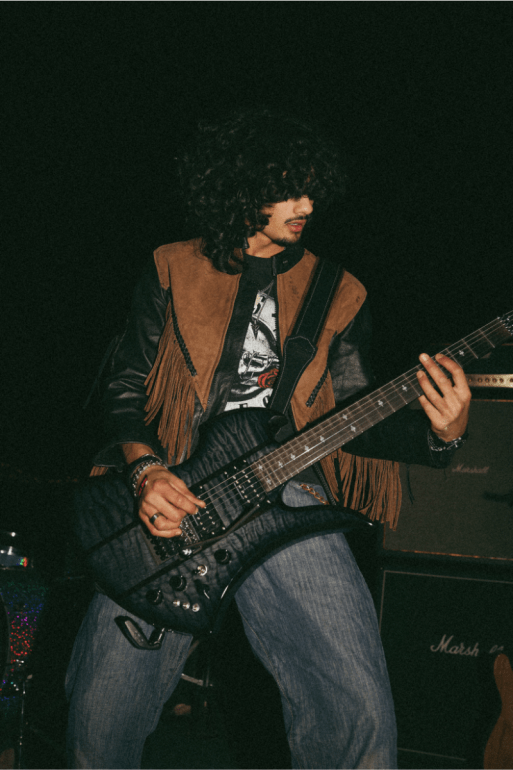 Lead guitarist Aydin Syed is pictured shredding on guitar.