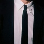 A black blazer with a white shirt and black tie being worn by The Dare.