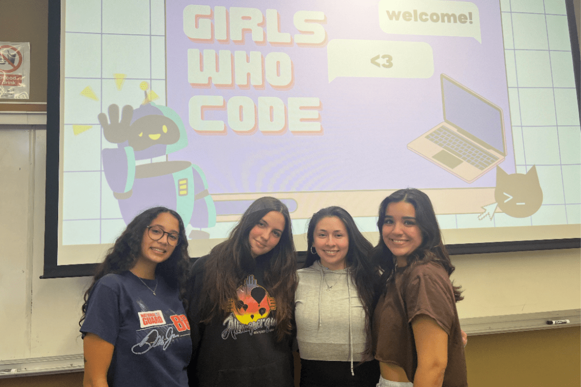 Four women in front of a projected powerpoint about the Girls Who Code Organization.