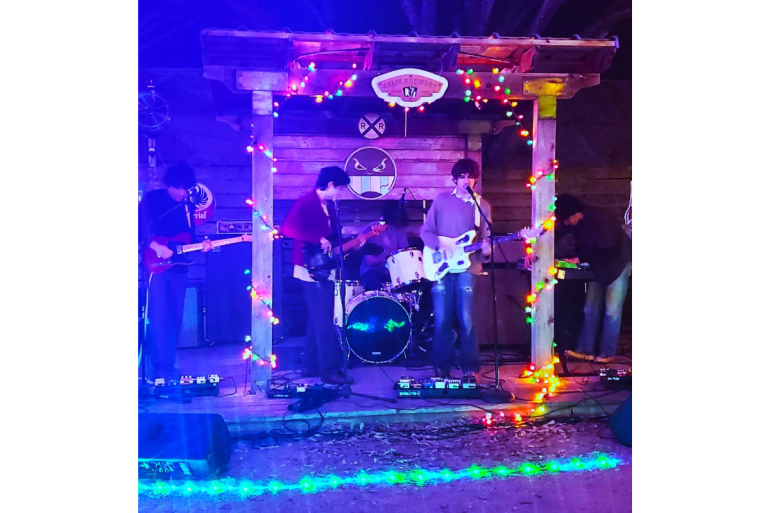 Witches exist performing under and around a pagoda-like structure with night lighting. 